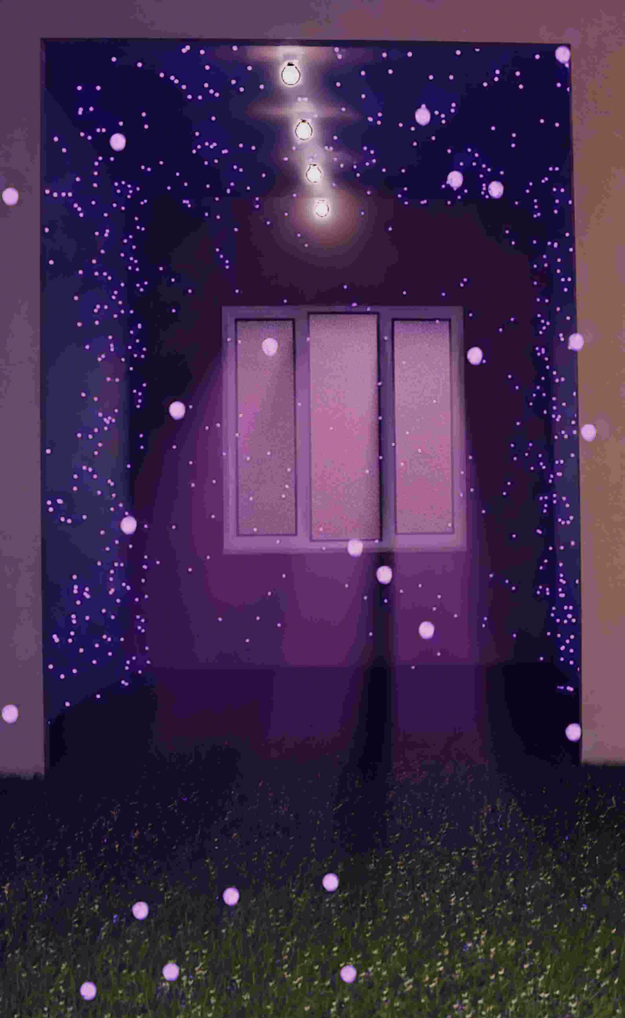 A window set in a purple-lit wall, with strings of small glowing lights scattered around and above, and grass visible on the ground.
